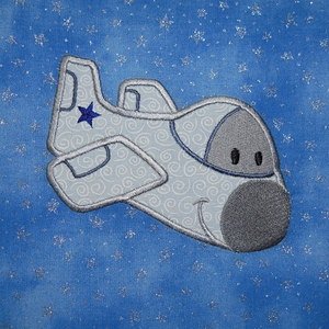 Picture of machine applique design that's part of the Airplane Adventures set of machine embroidery designs. White airplane with smiling face and eyes.. Perfect for boys or girls.